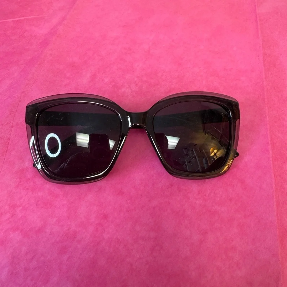 Black plastic frame with black tint. No case